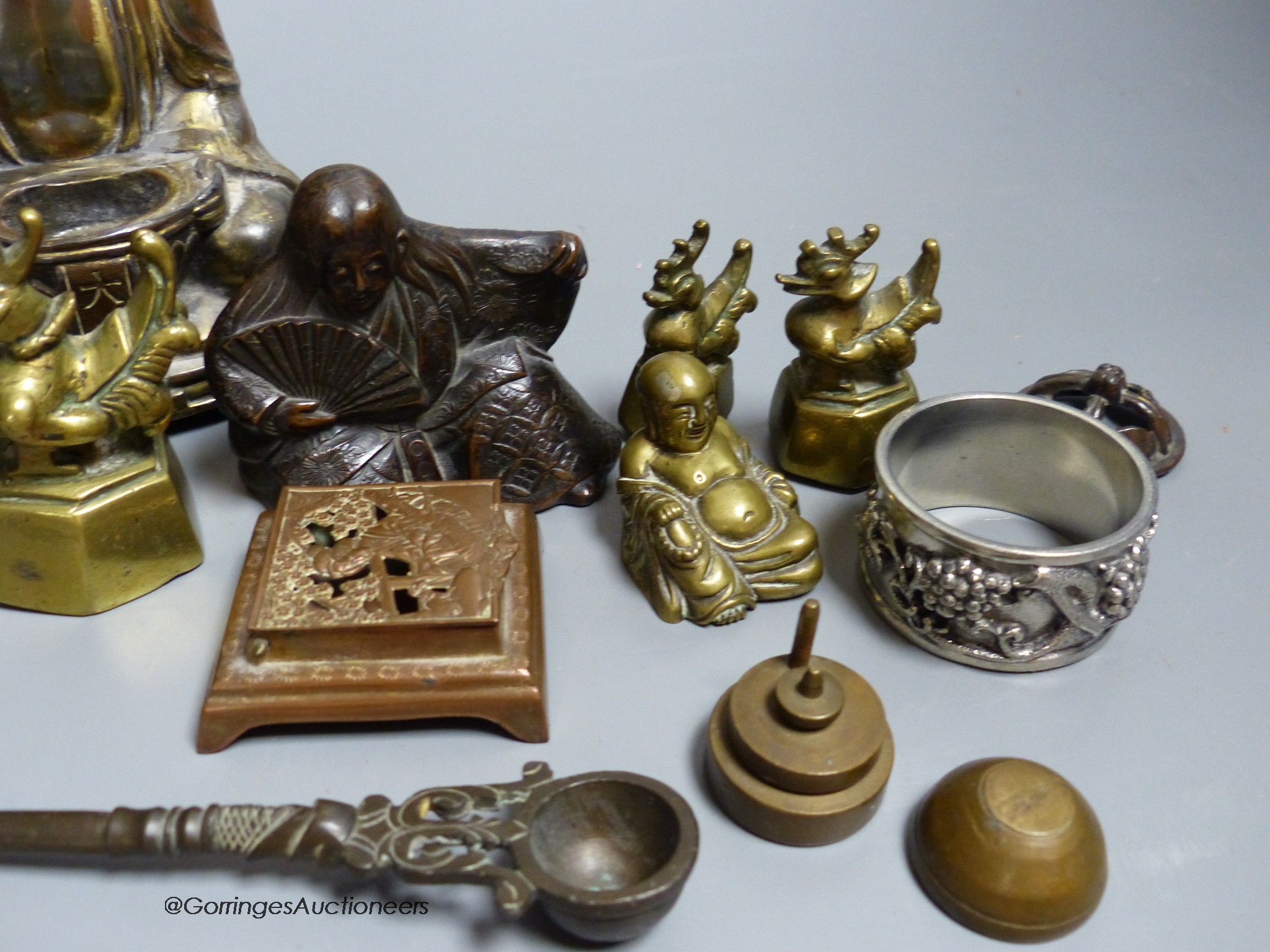 A group of mixed Oriental Buddha's, vases, weights, etc.